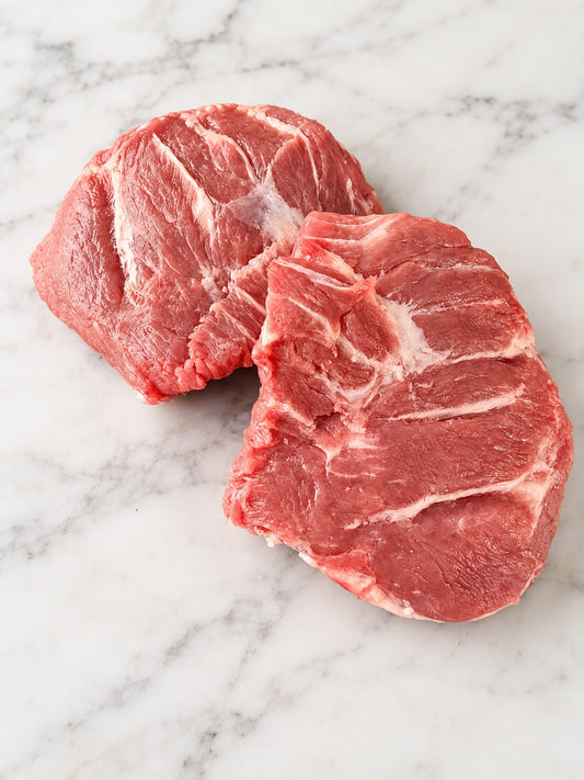 Two Berkshire pork cheeks on white marble, 100–120g per pack