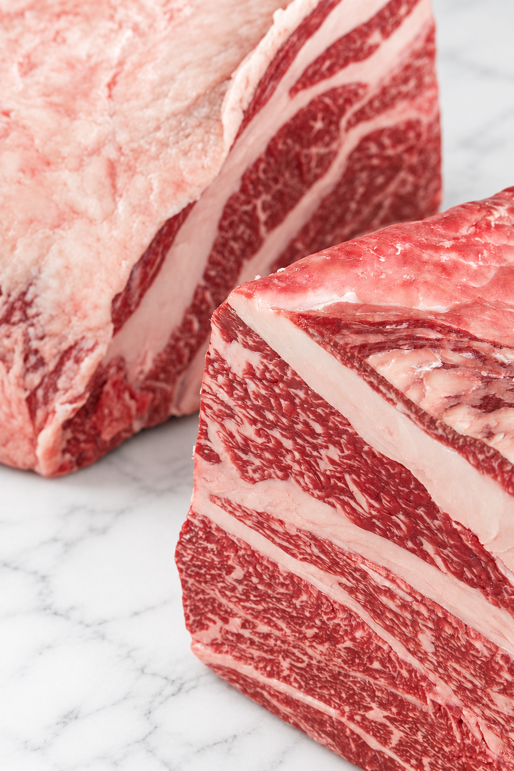 Close-up of Japanese Wagyu beef cuts and natural marbling on white marble