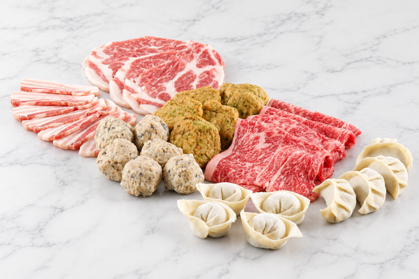 FAV Premium Hot Pot Set with Berkshire pork slices, A3 Wagyu, shiitake meatballs, fish cakes and eight Shanghai wontons on white marble