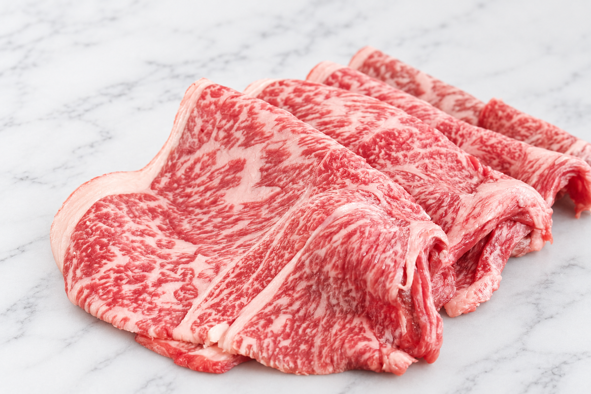 Thinly sliced Japanese A3 Wagyu for hot pot on white marble