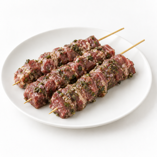 Three Ontario herbed lamb skewers on a white plate; illustrative photo
